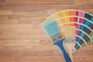 Color palette guide and brushes on wooden background with copy space, retro toned