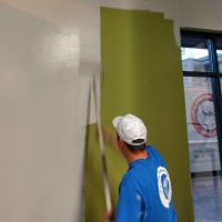 Man painting wall white in Bend OR